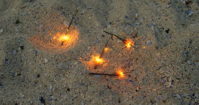 High angle view of sparklers on sand at beach. Sparkler sparkling on a sand 4k