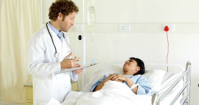 Doctor Consulting Patient in Hospital Bed - Download Free Stock Images Pikwizard.com