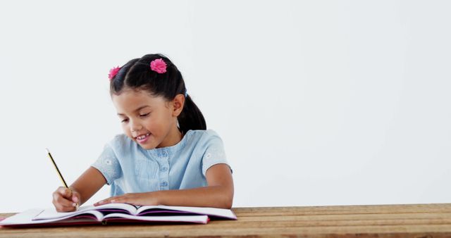 Young Girl Writing in Notebook at Wooden Table - Download Free Stock Images Pikwizard.com