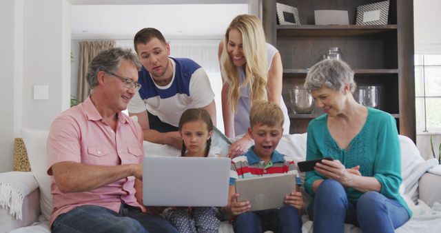 Multi-generational Family Using Laptops and Tablets in Living Room - Download Free Stock Images Pikwizard.com