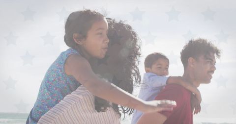 Diverse Family Celebrating American Patriotism on Beach Day