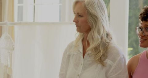 Bride Choosing Wedding Dress in Elegant Boutique with Thoughtful Expression