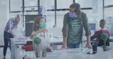 Office Workers in Masks Collaborating with Technology Overlays