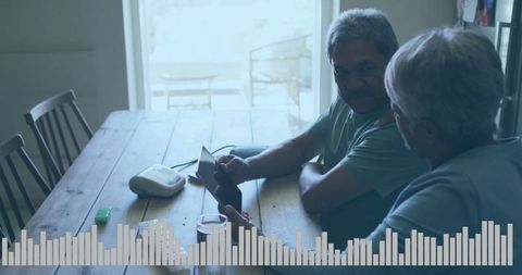 Senior Hispanic Couple Using Tablet for Medication Review at Home