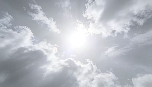 Sunburst Breaking Through Dramatic Clouds, Luminous Backlit Sky with Sun Rays, Monochrome