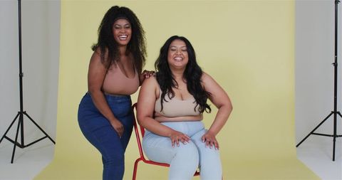 Diverse Women Friends Posing Cheerfully in Studio with Colorful Background