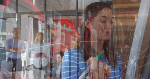 Businesswoman Analyzing Data with Real-Time Market Statistics Overlay