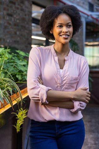 Confident african american woman in office corridor