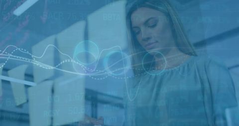 Businesswoman with Financial Data Overlay in Modern Office