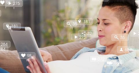 Engaged Woman Relaxing with Tablet and Social Media Icons Overlay