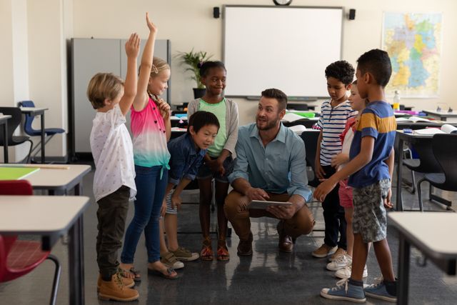 Teacher engaging with a group of diverse elementary school students in a classroom. Children are raising their hands, showing active participation and interest in the lesson. Ideal for educational content, school brochures, teaching materials, and articles on classroom engagement and diversity in education.