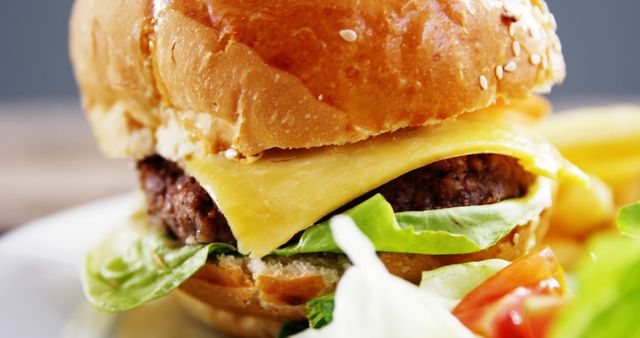 Close-up of a Juicy Cheeseburger with Lettuce and Tomato - Download Free Stock Images Pikwizard.com