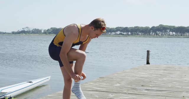 Athlete Prepares for Rowing by Lakeside with Fresh Socks - Download Free Stock Images Pikwizard.com