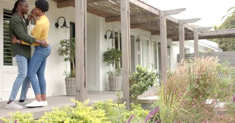 Romantic Couple Dancing on Wooden Deck with Pergola