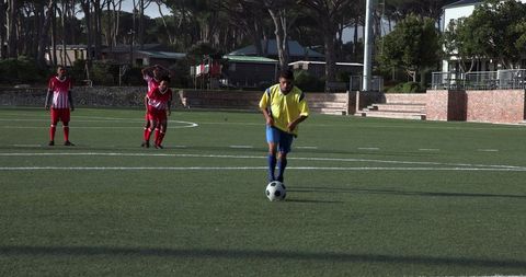 Soccer Player Kicking Ball During Practice Session on Field