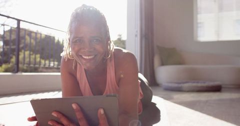 Happy Senior Woman Using Tablet in Bright Room