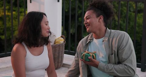 Couple Sharing Laughs on Patio During Celebration