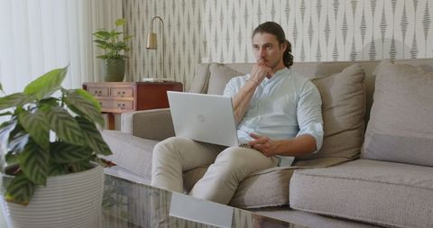 Man Working on Laptop in Modern Home Interior