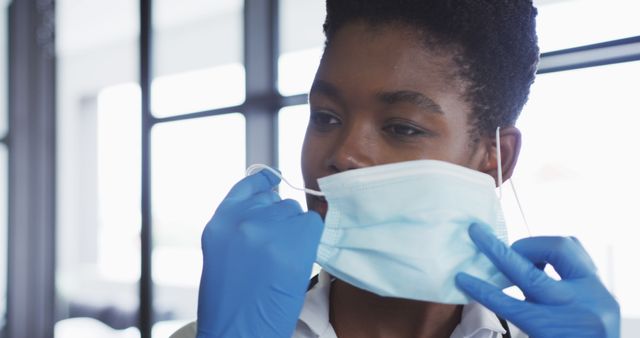 Healthcare Worker Putting On Protective Medical Mask - Download Free Stock Images Pikwizard.com