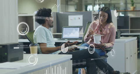 Colleagues Analyzing Financial Data in Modern Office