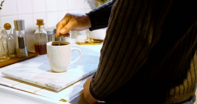 Person Stirring Coffee in Cozy Kitchen - Download Free Stock Images Pikwizard.com