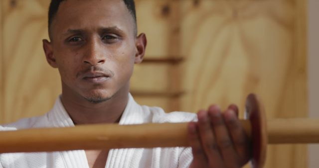 Focused Black Man Holding Wooden Training Sword - Download Free Stock Images Pikwizard.com