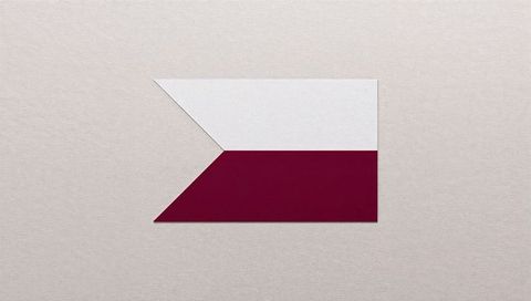 Minimalist geometric paper cutout white trapezoid maroon band on textured beige fabric