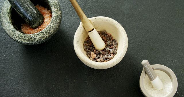 Various Mortar and Pestles Grinding Different Salts on Dark Surface - Download Free Stock Images Pikwizard.com