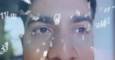 Indian man gazing through data reflection with floating numeric overlay and teal particles