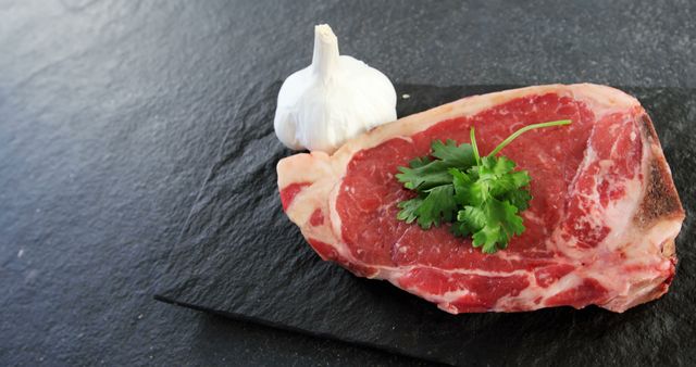 Raw Marbled Steak with Parsley and Garlic on Slate Background - Download Free Stock Images Pikwizard.com