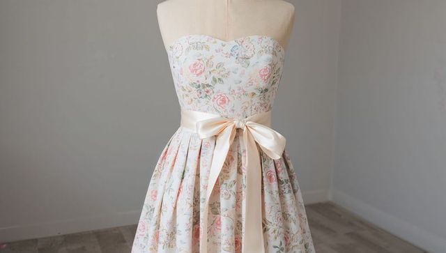Floral strapless dress with ivory satin bow on mannequin