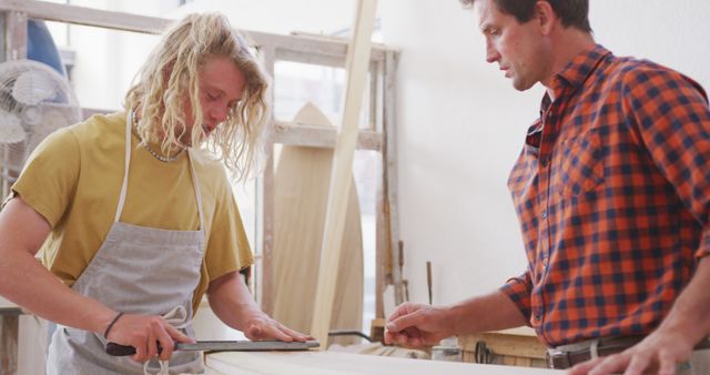 Young Carpenter Learning from Experienced Mentor in Woodworking Shop - Download Free Stock Images Pikwizard.com