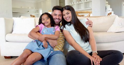 Smiling Family Bonding in Cozy Living Room Environment
