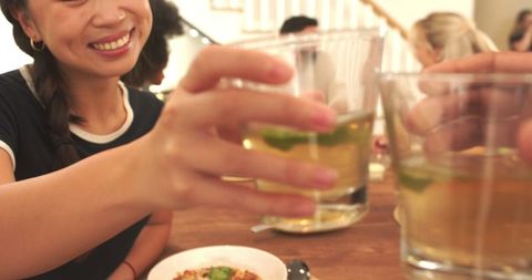 Diverse Friends Toasting Over Meal in Casual Restaurant