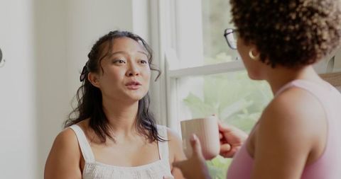 Women Engaged in Deep Conversation by Sunlit Window