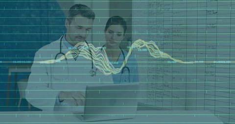 Medical professionals analyzing patient data on laptop in clinic