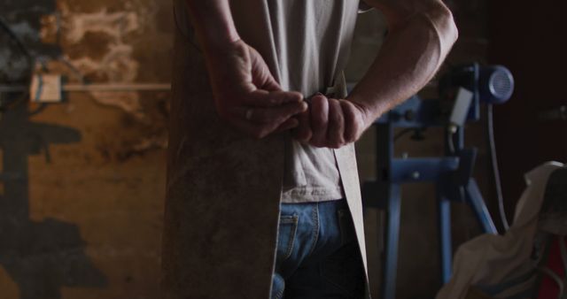 Carpenter fastening work apron in workshop - Download Free Stock Images Pikwizard.com