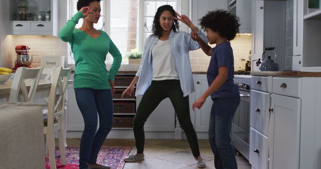 Happy Family of Three Dancing Together in Kitchen - Download Free Stock Images Pikwizard.com