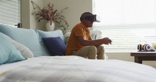 Image of happy african american boy using vr headset and playing image games at home - Download Free Stock Photos Pikwizard.com