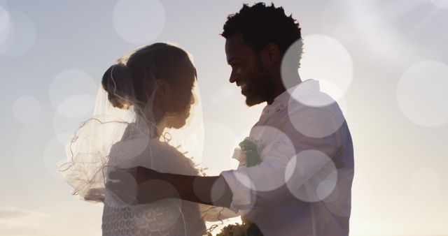 Image of dots over happy african american newly married couple on beach. Holidays, vacations love, marriage concept digitally generated image.