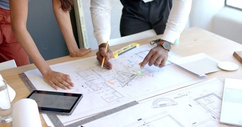 Collaborative Discussion Over Blueprints with Technology - Download Free Stock Images Pikwizard.com