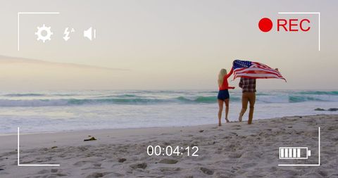 Beach Scene with Couple Holding American Flag