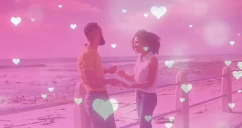 Romantic Couple with Heart Graphics Holding Hands by Seaside