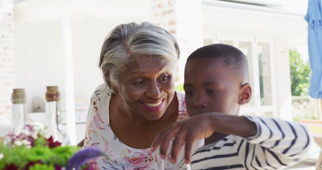 Image of african american grandmother and grandson cooking having dinner outside - Download Free Stock Photos Pikwizard.com