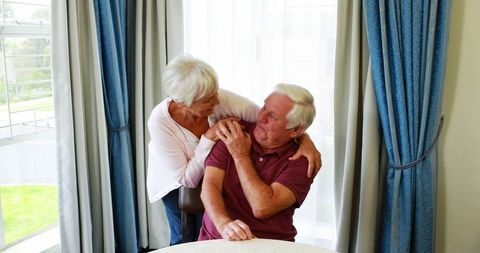 Smiling Senior Couple Enjoying Time Together in Pleasant Living Space