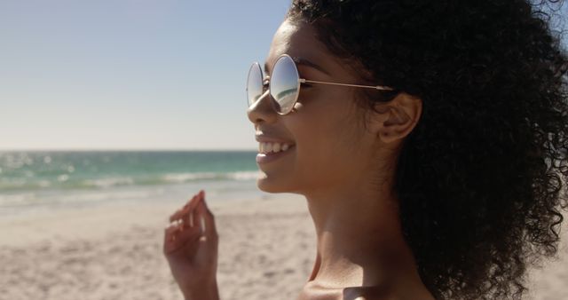 Happy Woman Enjoying Sunny Day at Beach with Sunglasses - Download Free Stock Images Pikwizard.com