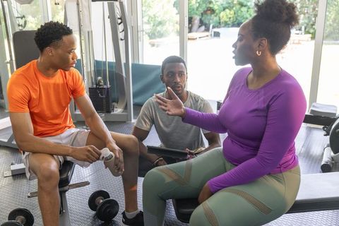 African american group discussing workout plan during small group training session