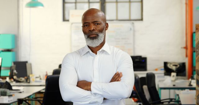 Confident Mature Businessman Standing with Arms Crossed in Modern Office - Download Free Stock Images Pikwizard.com