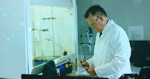 Senior Scientist Collecting Research Data at Laboratory Fume Hood