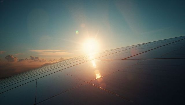 Sunset Reflection on Airplane Wing Extending into Horizon